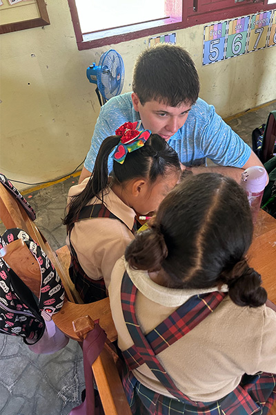 Ethan Clites helps students in Belize learn.